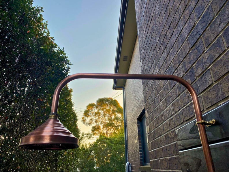 Slim copper outdoor shower with brass head for gardens and patios