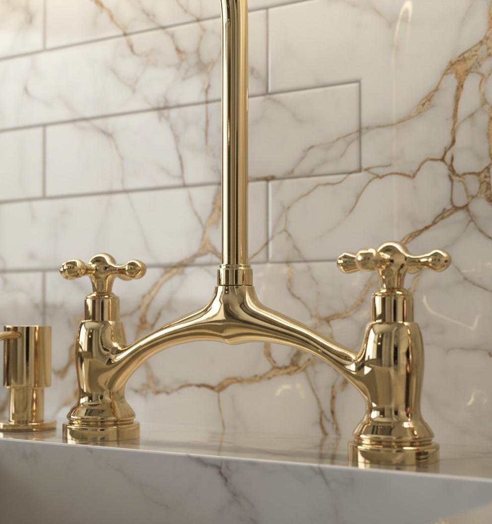 Gold faucet set against a marble wall