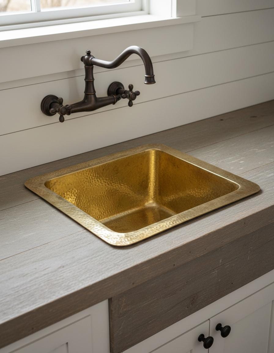 Gold sink with bronze faucet on a wooden countertop