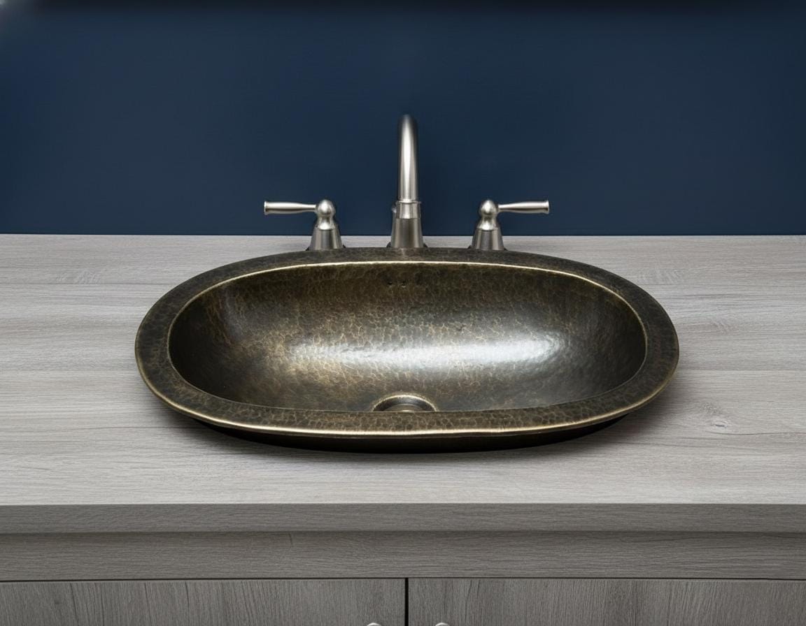 Bronze sink on a wooden countertop with a blue wall background