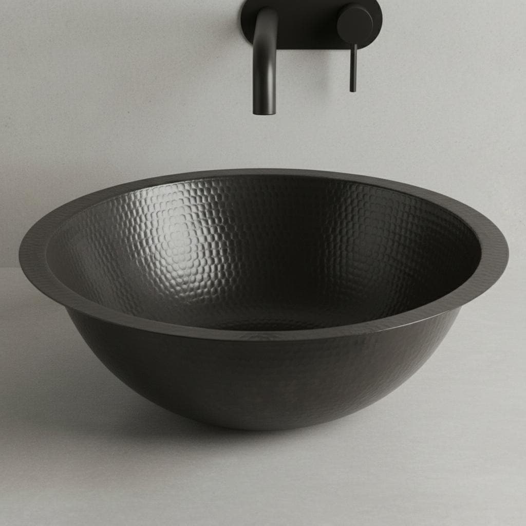 Black hammered sink with a wall-mounted faucet on a light gray background