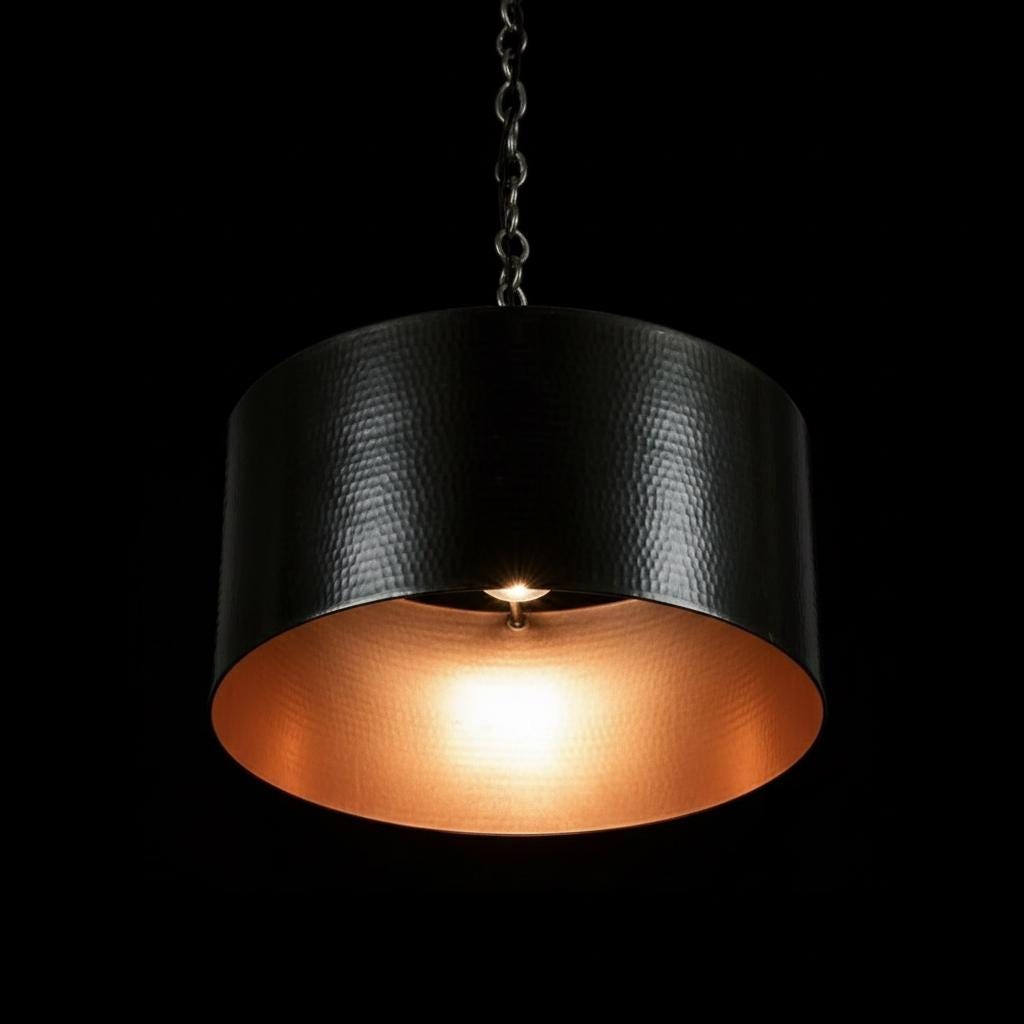 Pendant light with black and gold shade on a black background