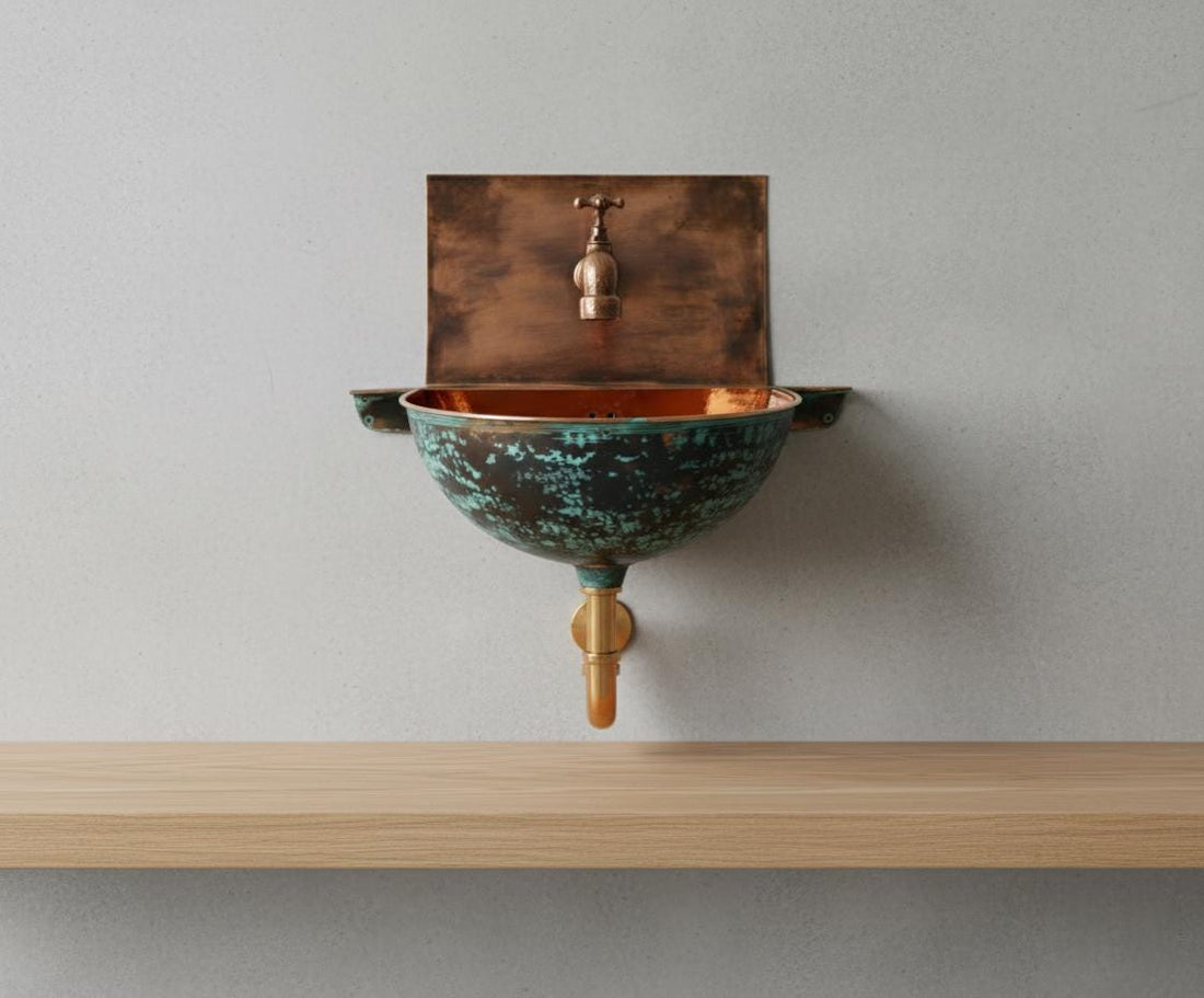 Wall-mounted copper sink with a textured bowl on a tiled wall background
