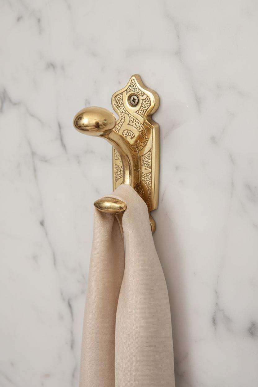 Decorative gold hook with pearls and a key on a blue background