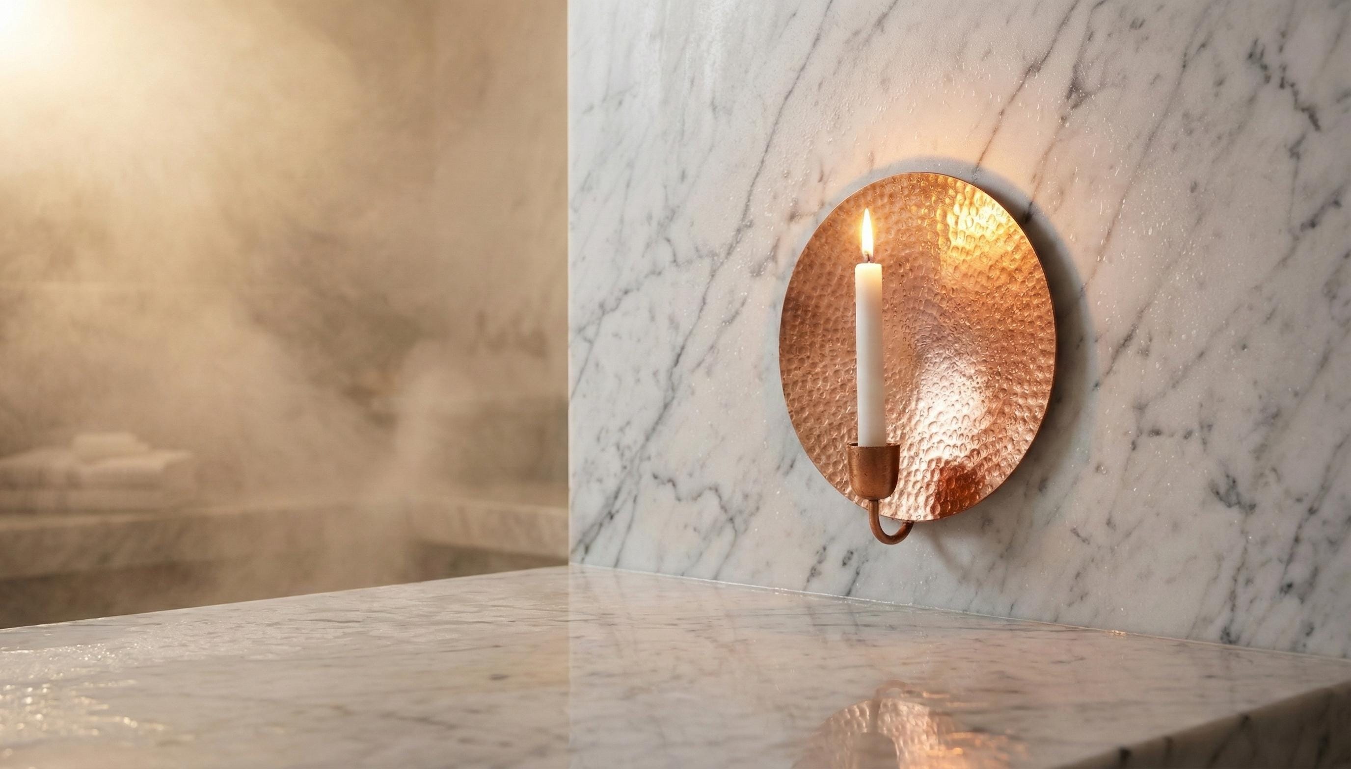 Copper wall sconce on a marble wall