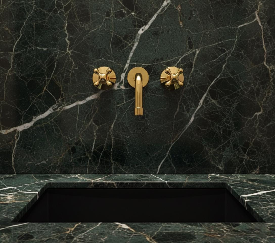 Gold faucet and handles on a dark marble wall with matching countertop
