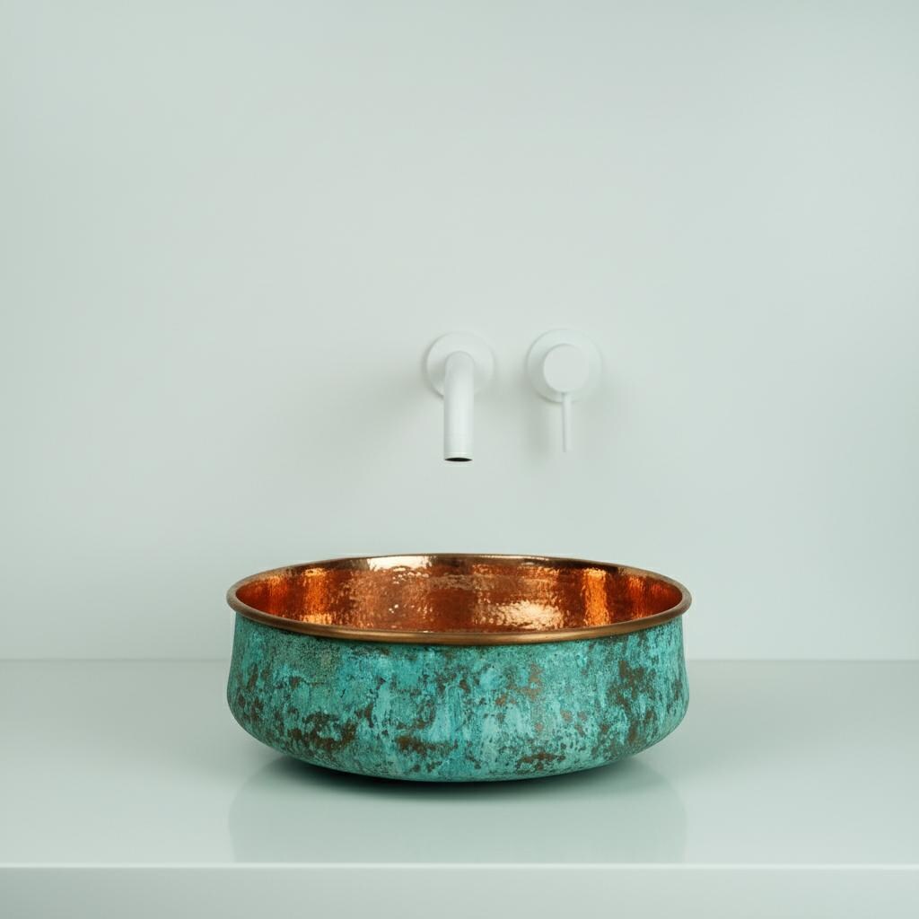 Copper and turquoise sink with a white faucet on a light gray background