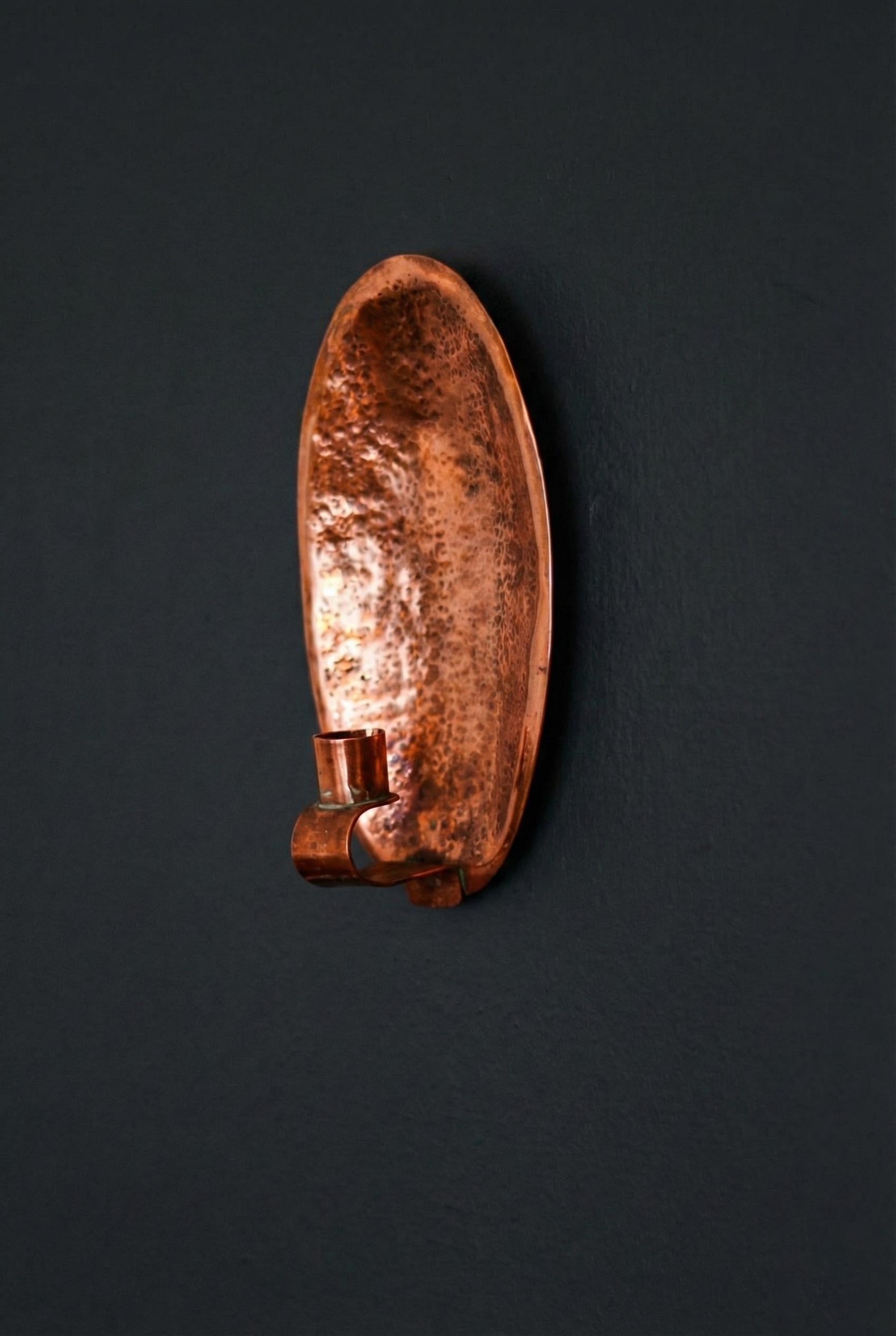 Copper wall sconce on a black background