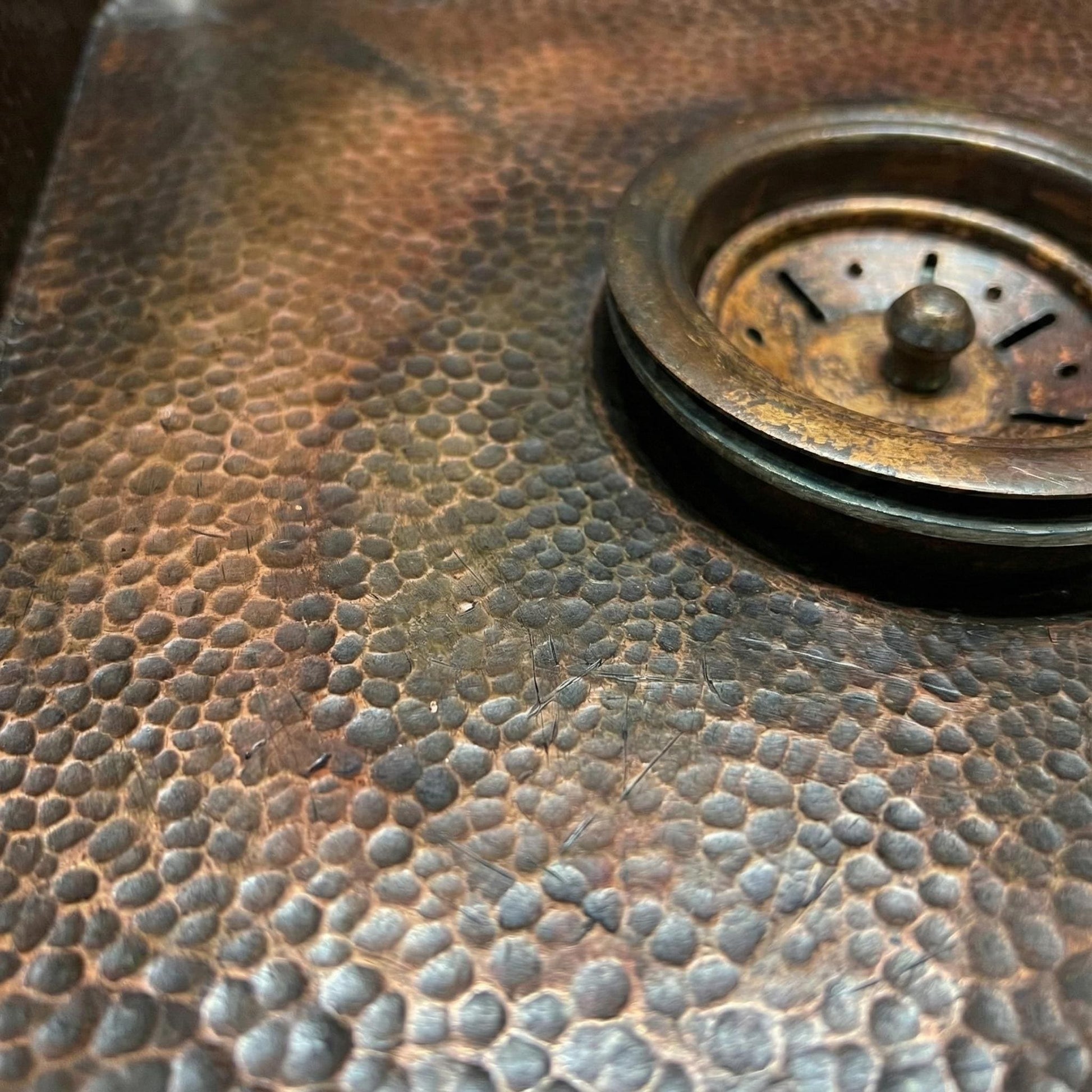 Close-up of a textured metal surface with a central circular component.