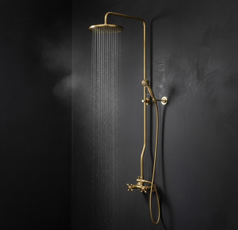 Gold shower set against a dark blue tiled wall