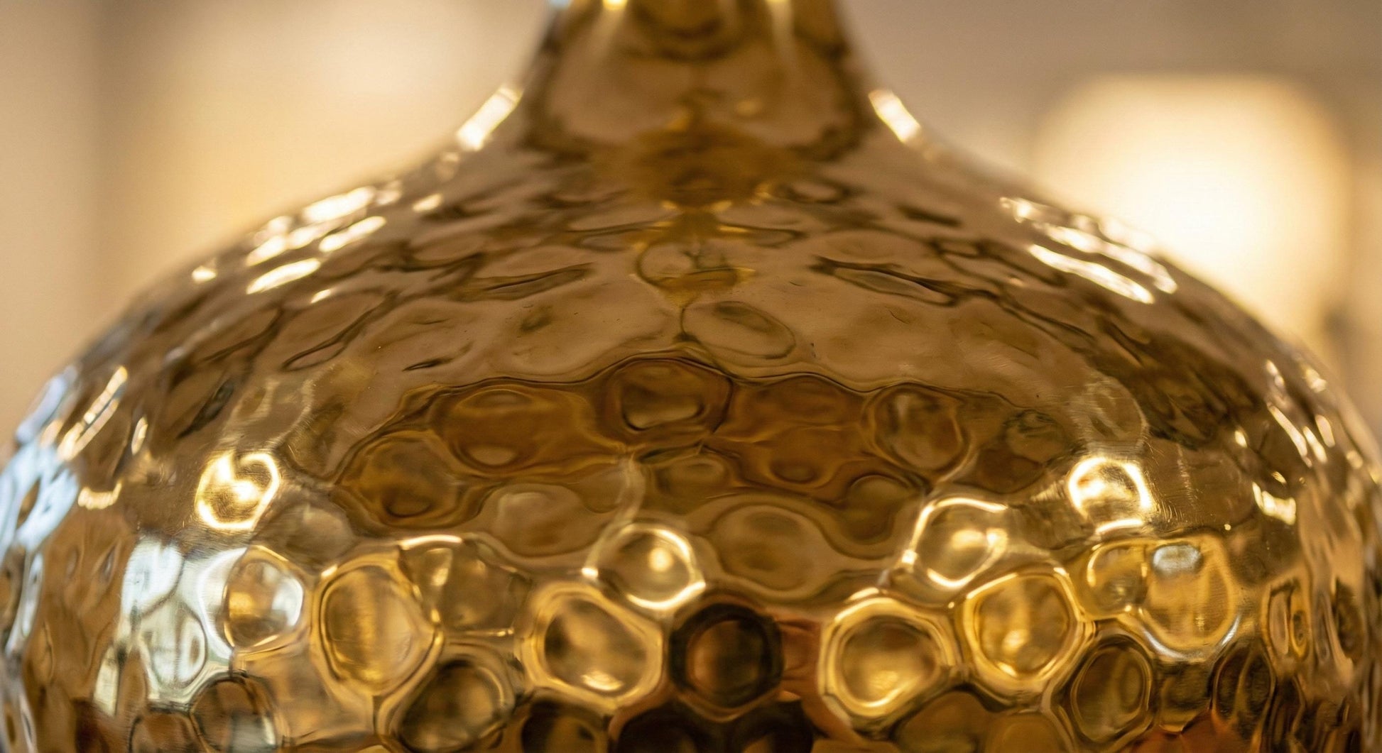 Close-up of a gold textured vase with a blurred background