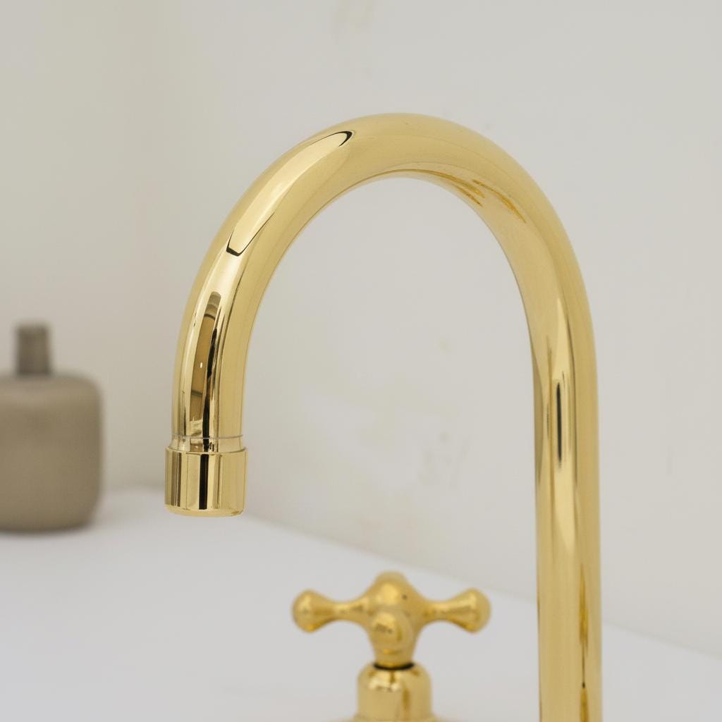 Gold kitchen faucet on a light background