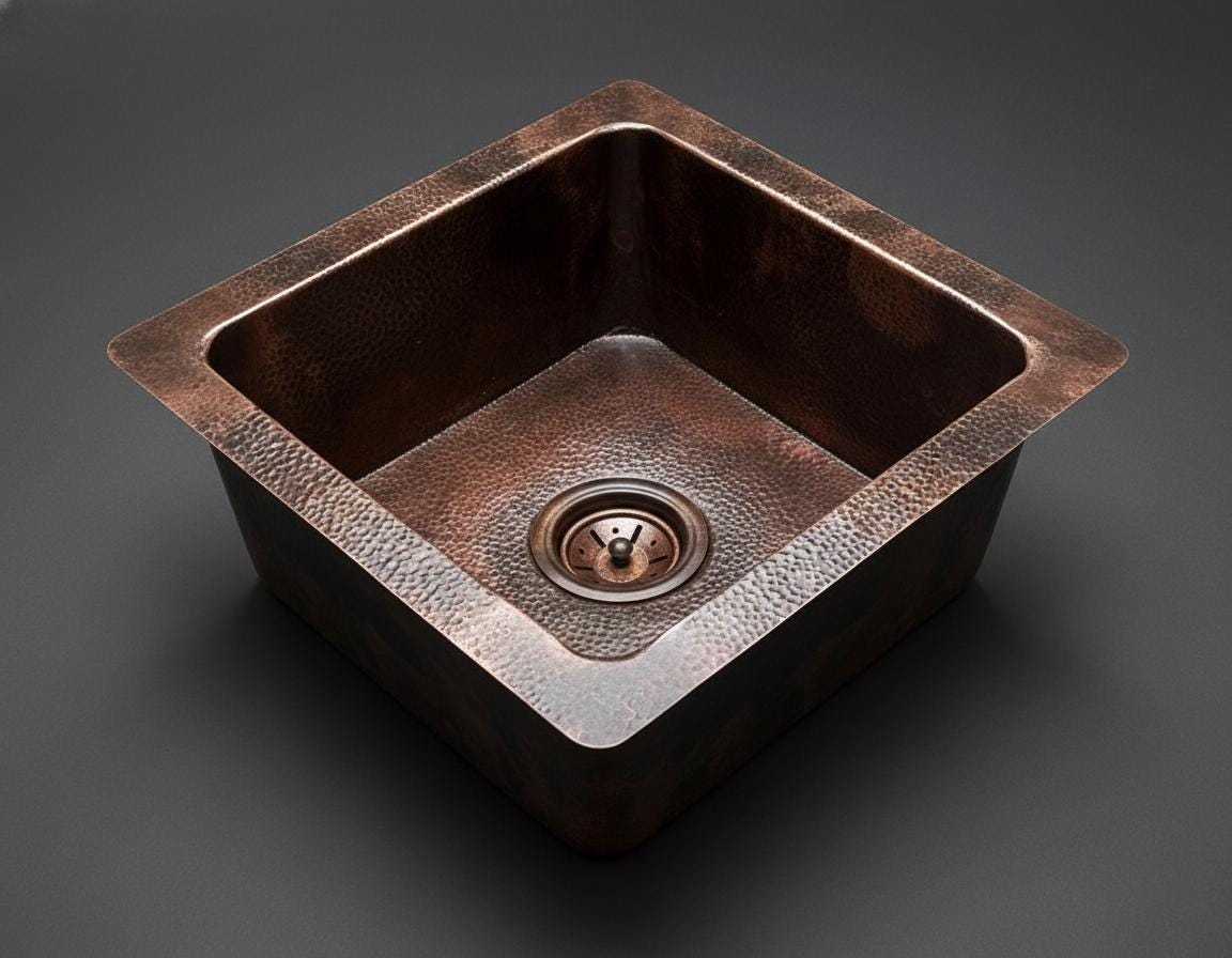 Copper kitchen sink on a dark background