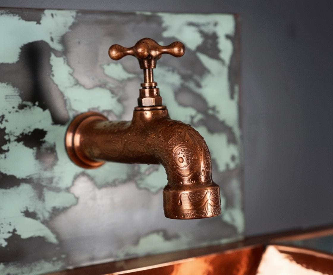 Bronze faucet on a textured wall background