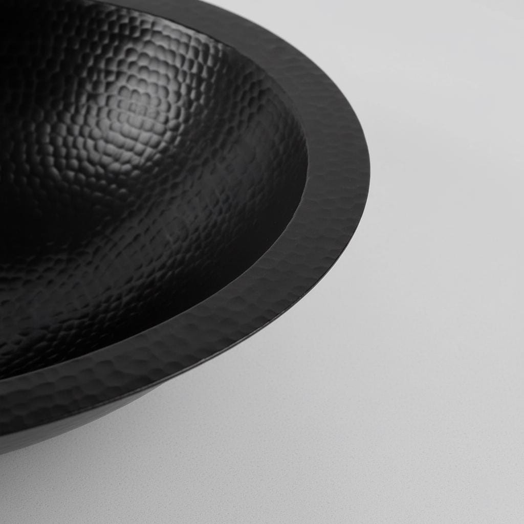 Black textured bowl on a light gray background