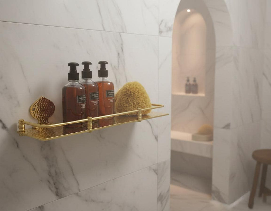 Shower area with a gold soap dish holding a black bottle and a white brush against a dark tiled wall.