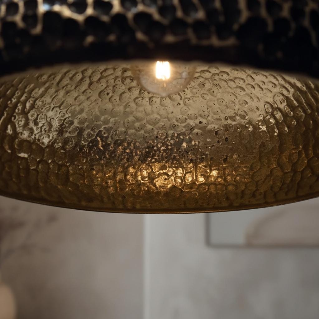 Close-up of a textured gold lampshade with a blurred background