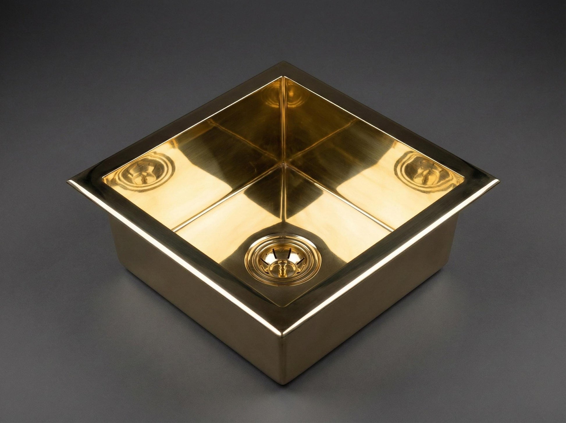 Gold square object with reflective surface on a dark gray background