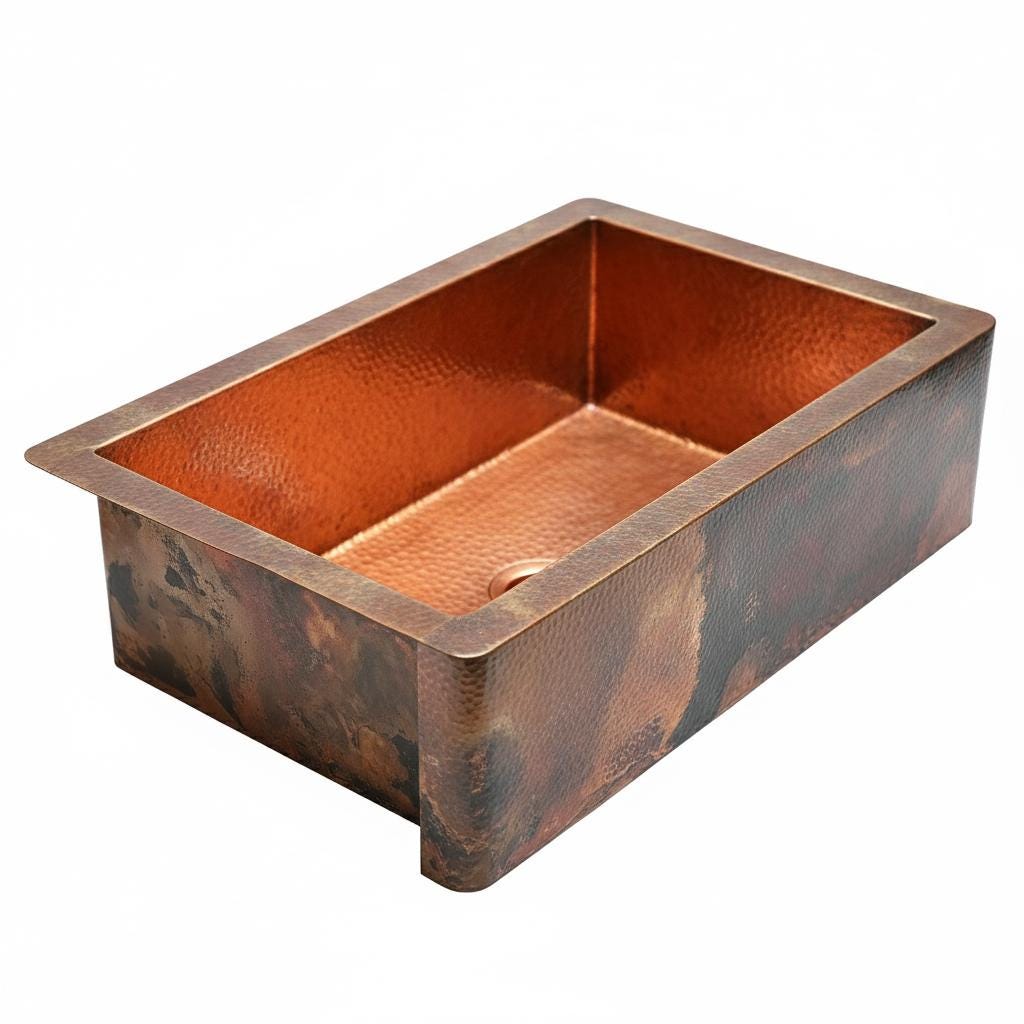 Copper kitchen sink with a hammered finish on a white background