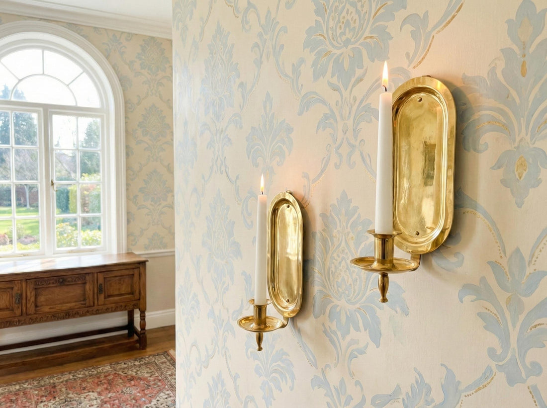 Decorative wall sconces with candles on a wall with intricate pattern