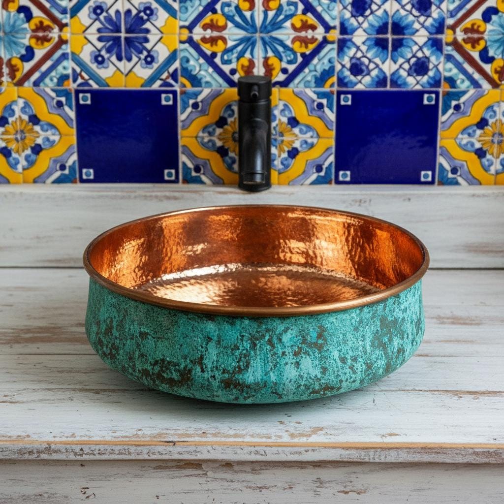 Copper sink with textured turquoise finish against a colorful tiled wall.