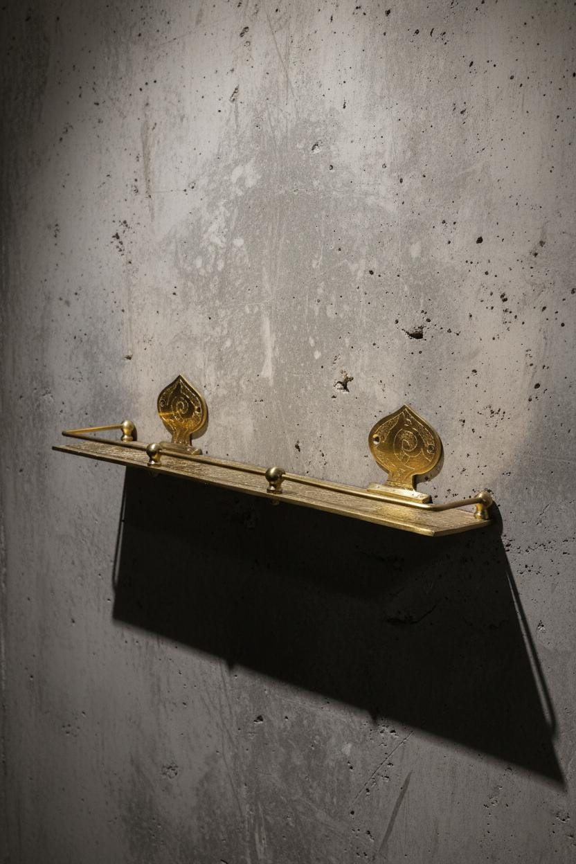Black clutch bag with gold accents on a textured gray background