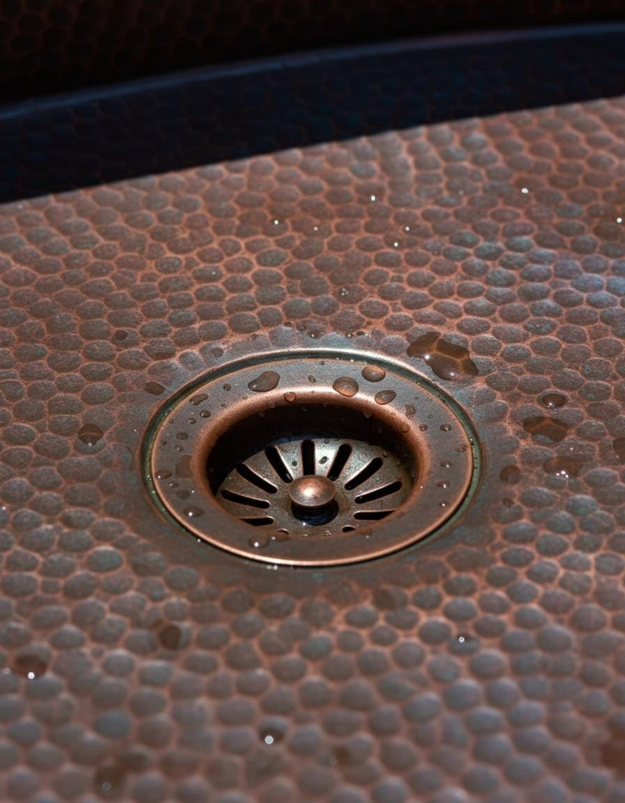 Close-up of a copper drain with textured surface