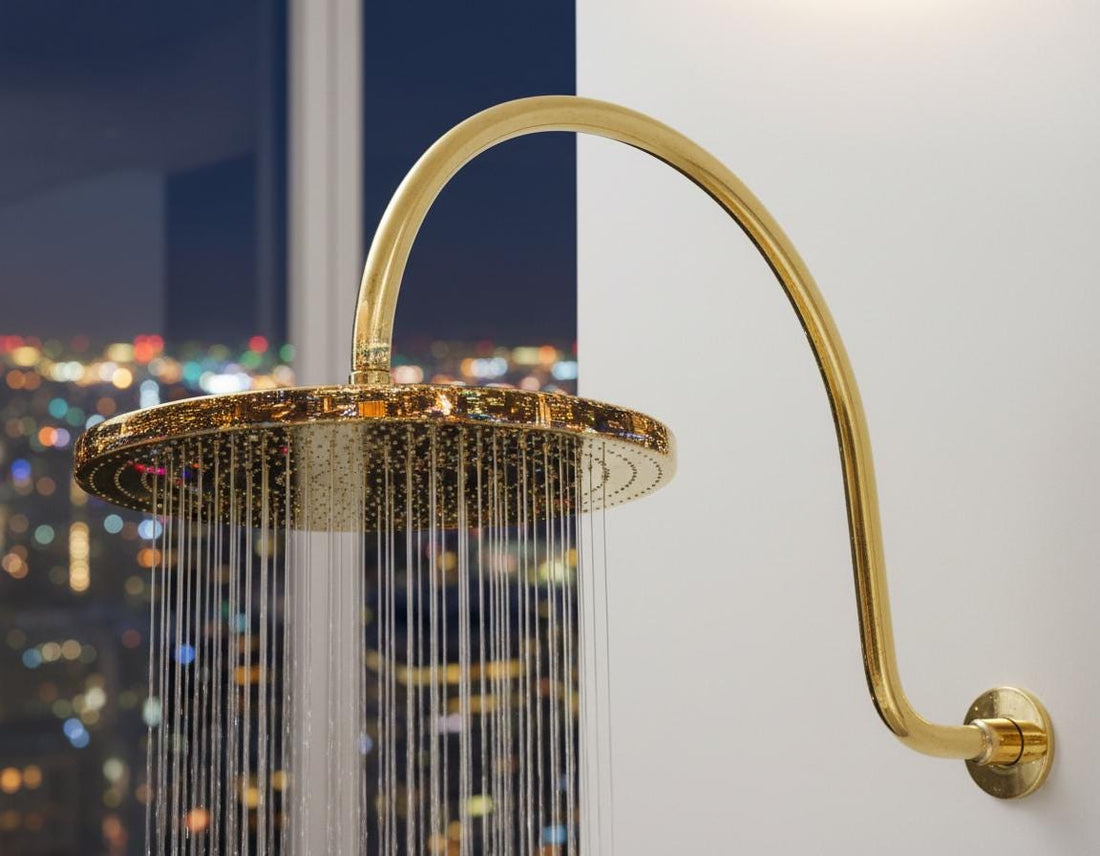 Gold shower head mounted on a tiled bathroom wall