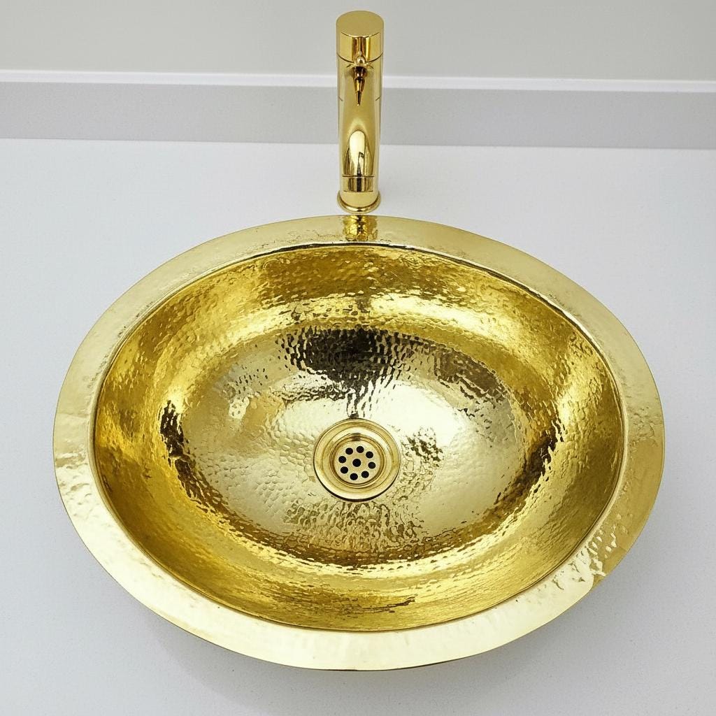 Gold sink with faucet on a white background