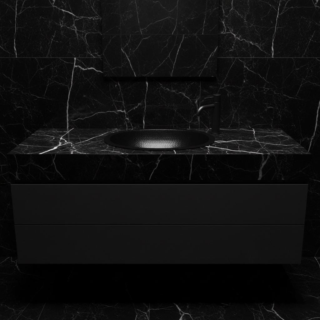 Black marble bathroom vanity with sink and faucet against a dark marble wall.