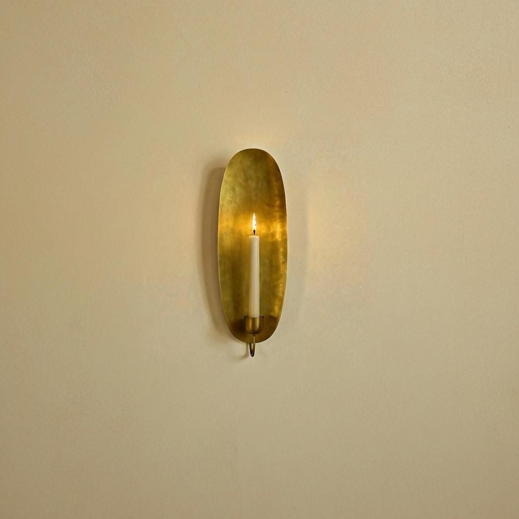 Brass wall sconce on a beige wall