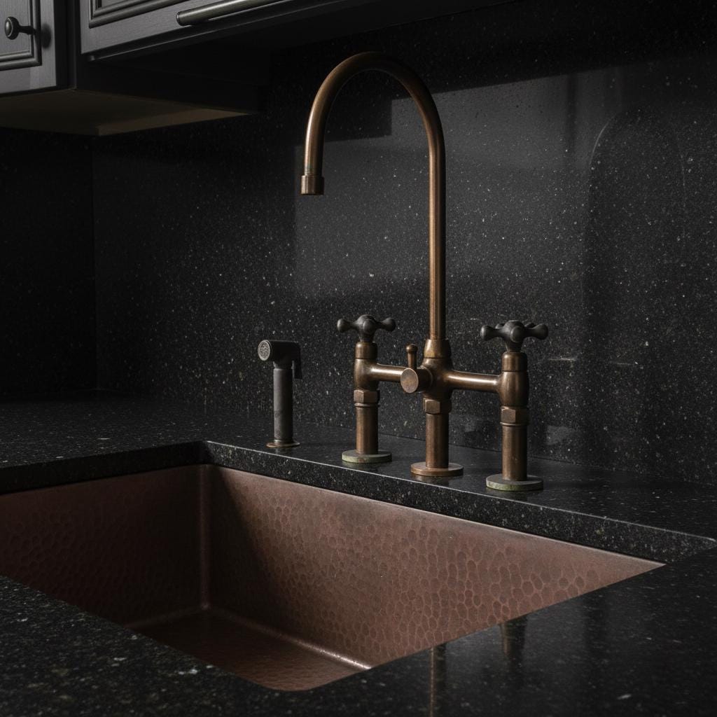 Bronze faucet and sink on a black speckled countertop