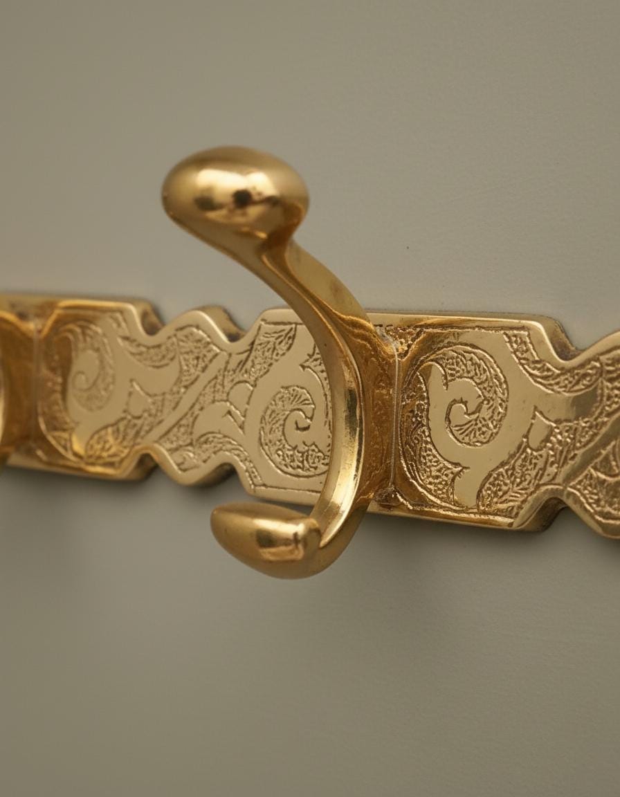Gold decorative object with intricate patterns on a gray background