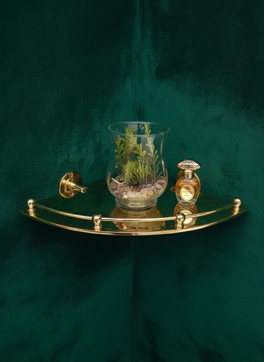 Gold tray with a glass container and decorative bottle on a green background