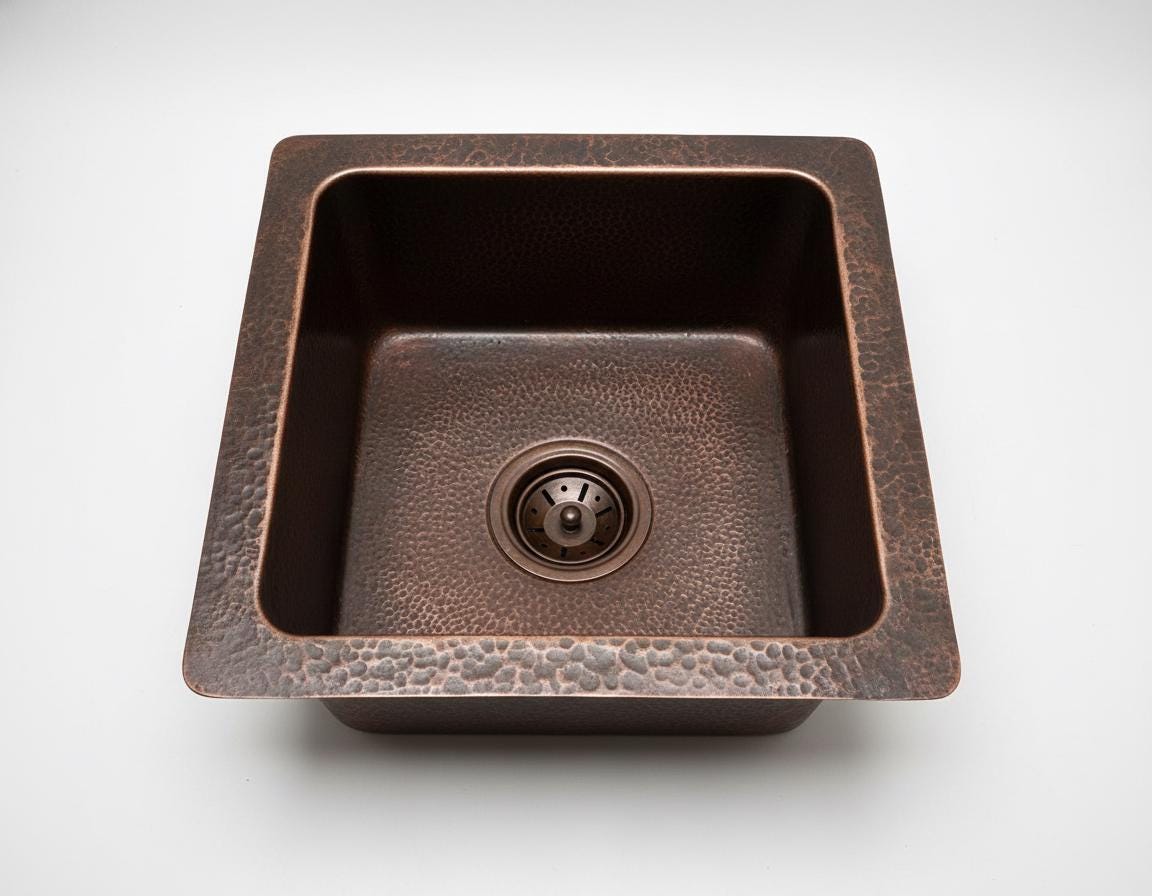 Copper kitchen sink on a white background