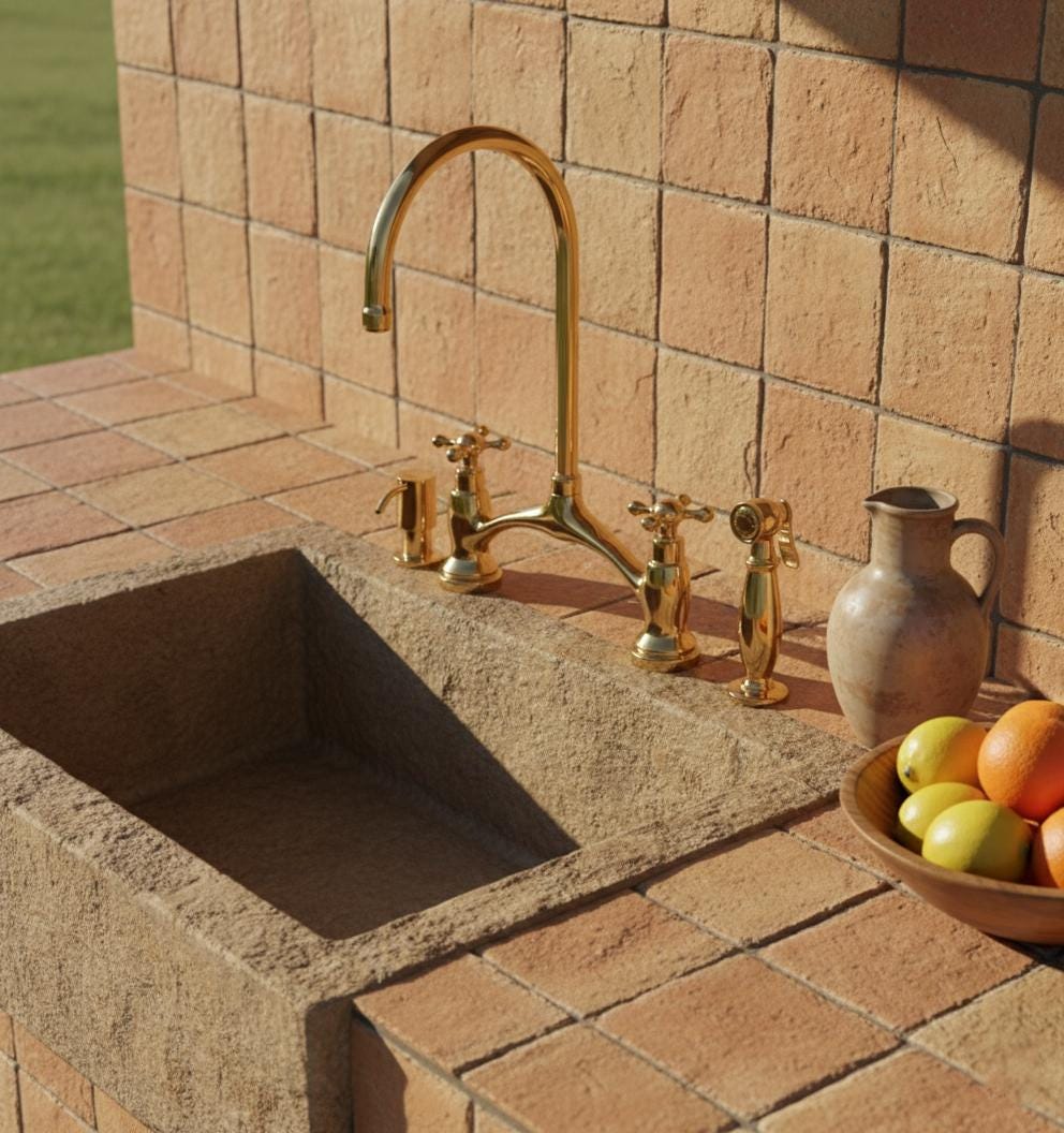 Outdoor stone sink with gold faucet and tiled wall