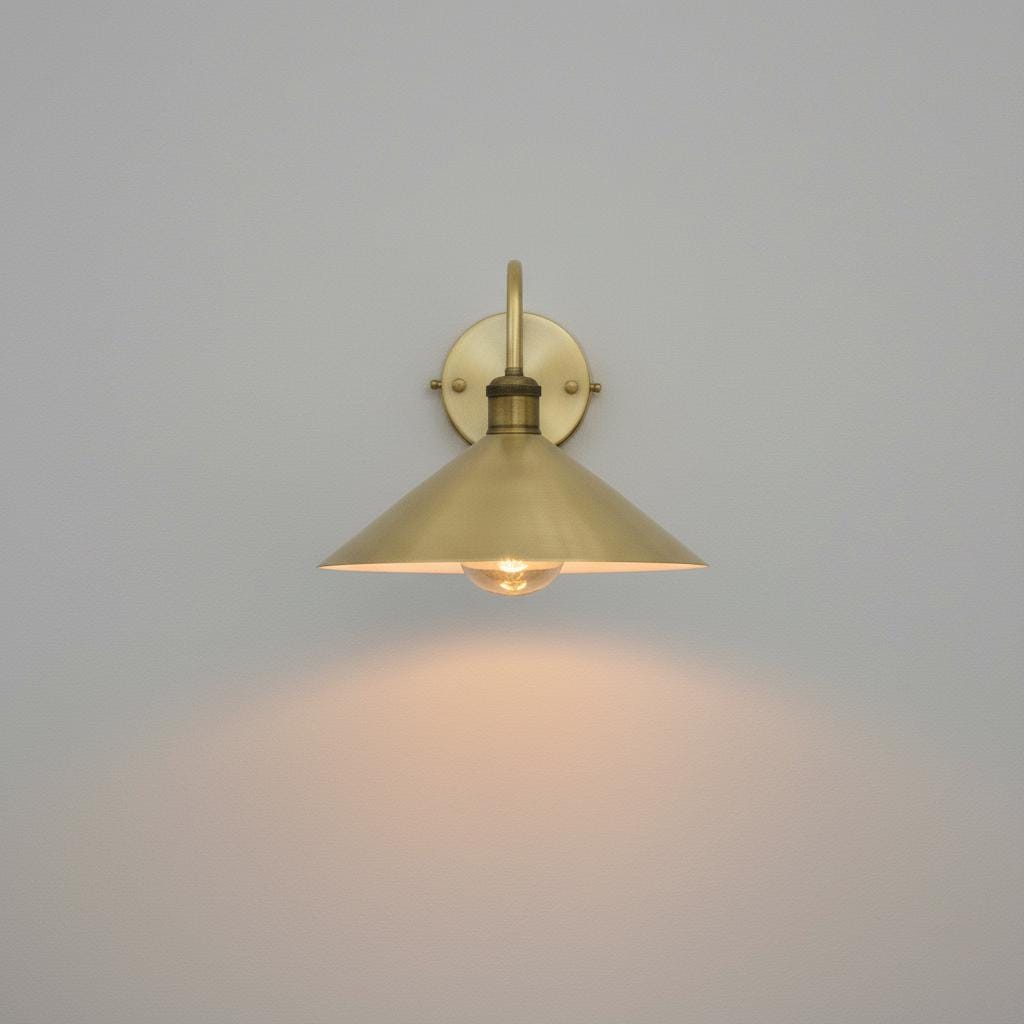 Brass wall sconce on a gray background