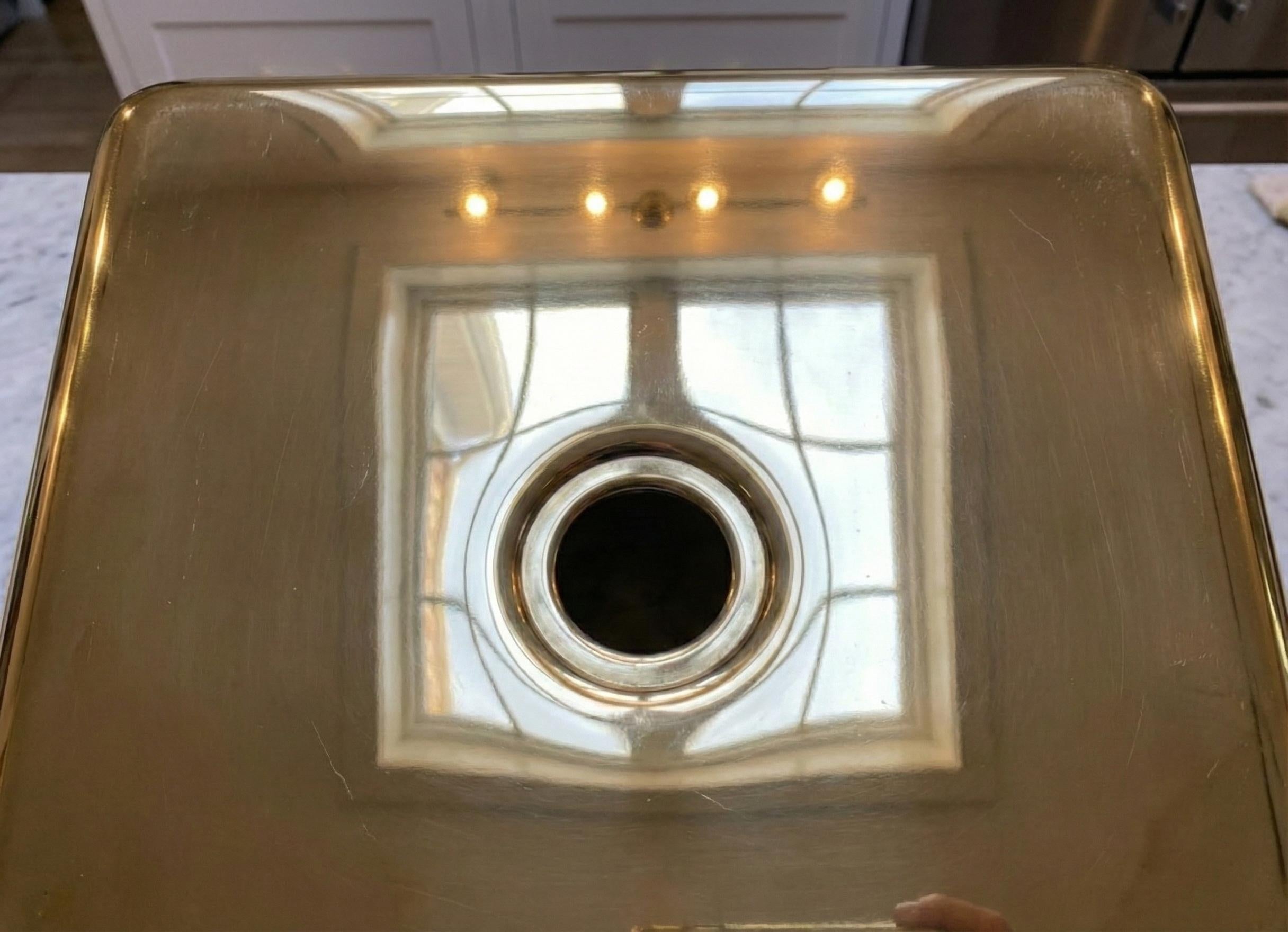 brass sink with reflective surface