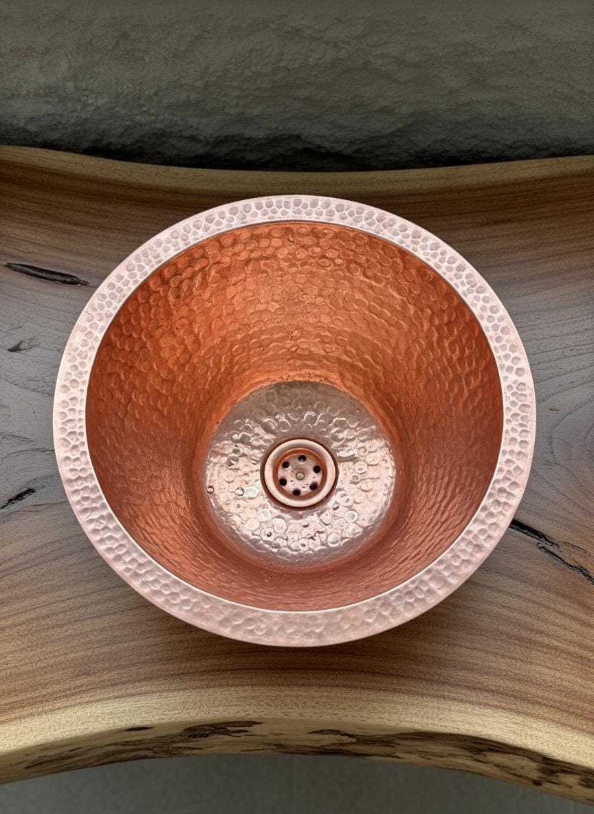 Copper sink with textured design on a wooden surface