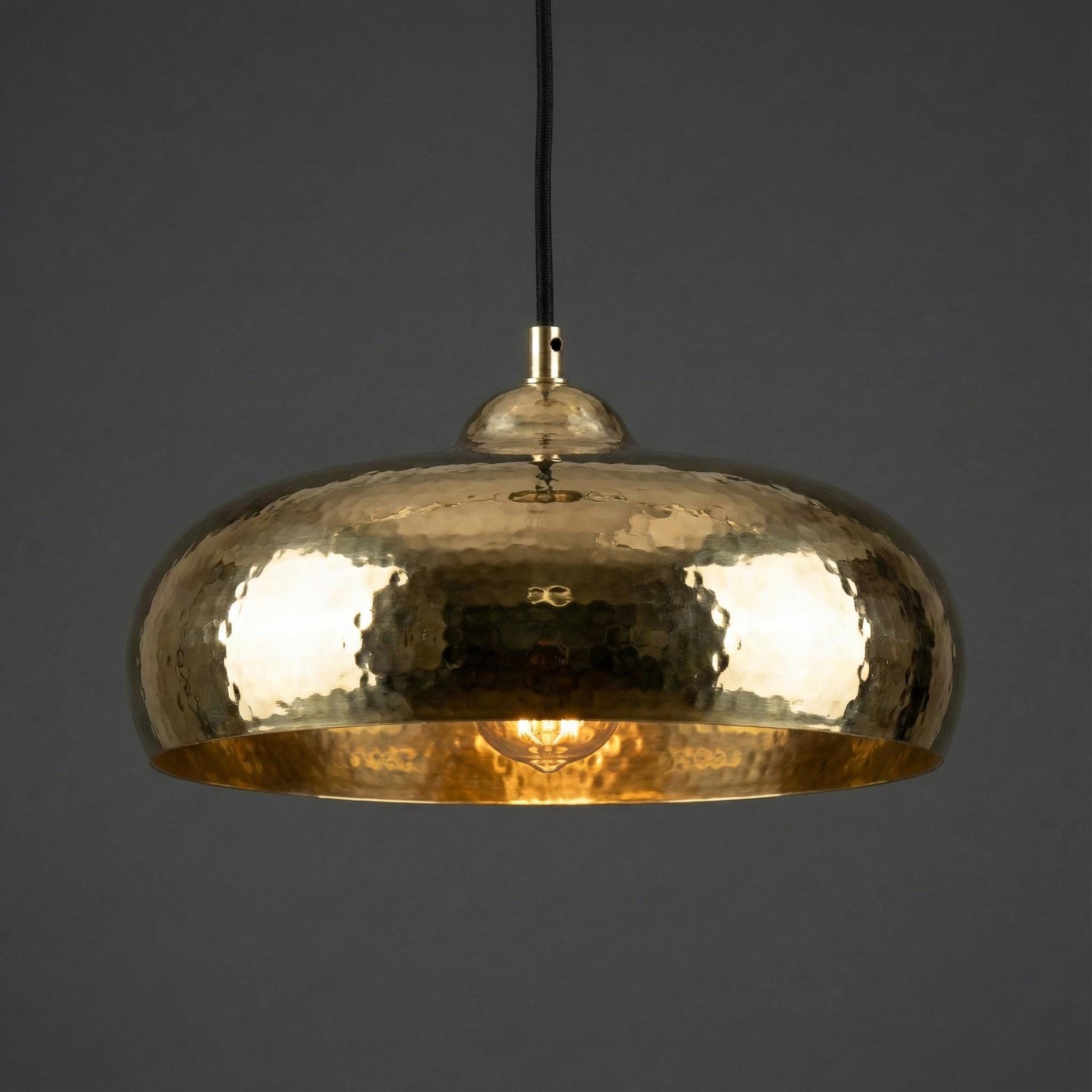 Gold pendant light on a dark background