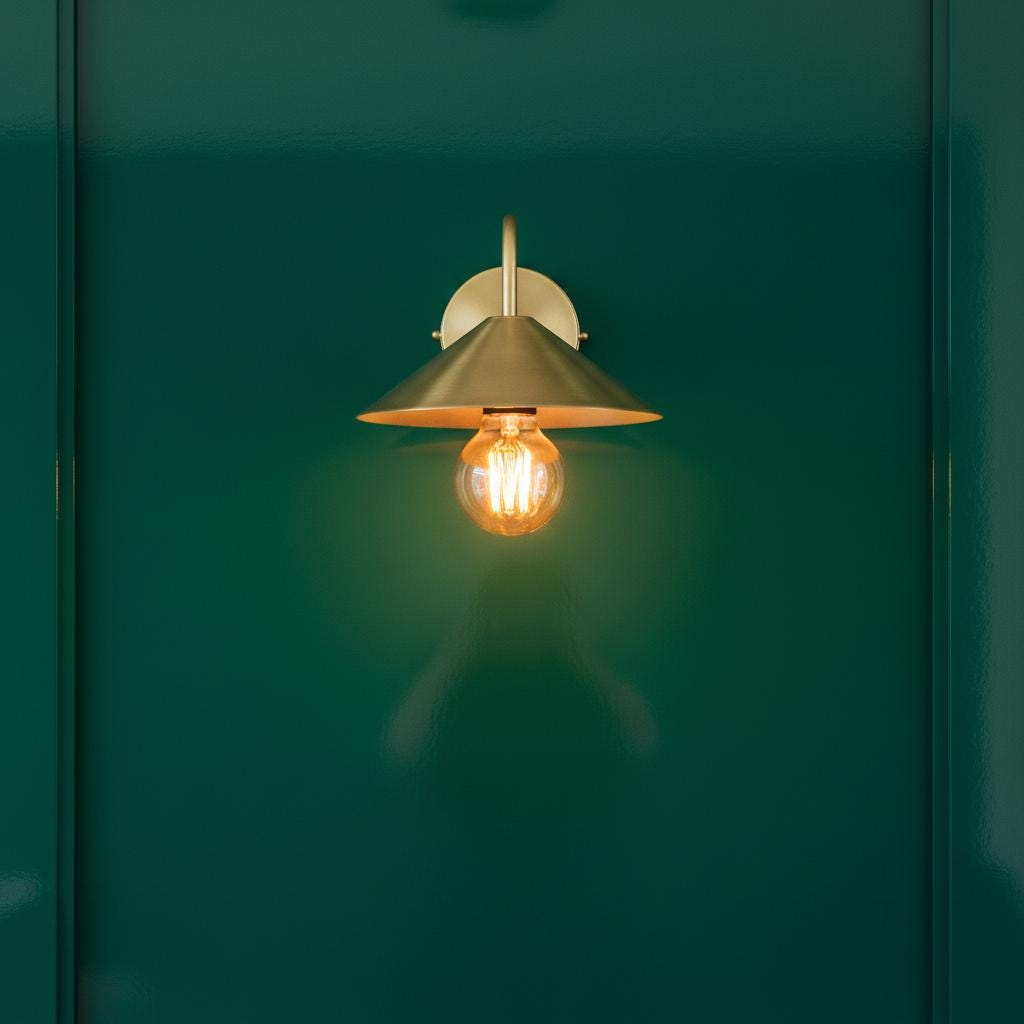 Wall-mounted light fixture with a glowing bulb on a green background