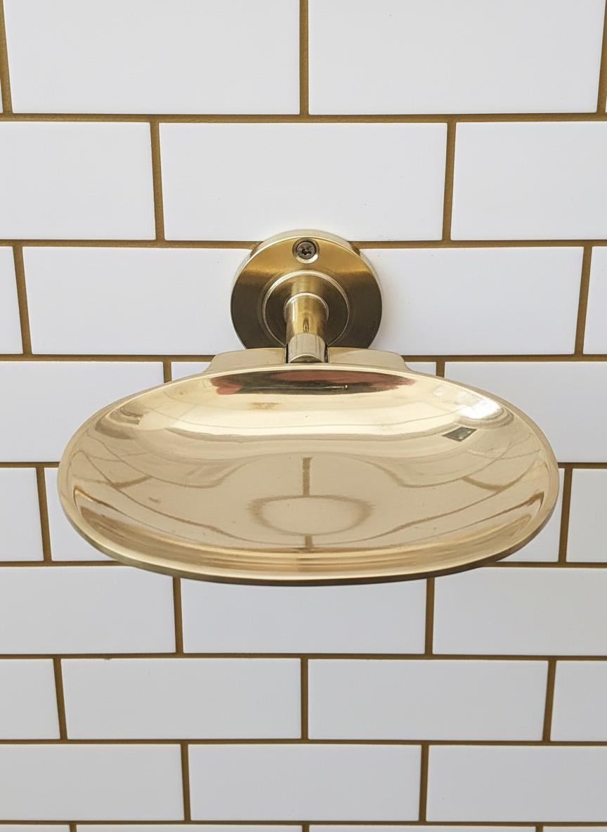 Gold shower head mounted on a tiled bathroom wall