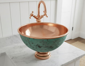 Copper sink with green patina on a marble countertop