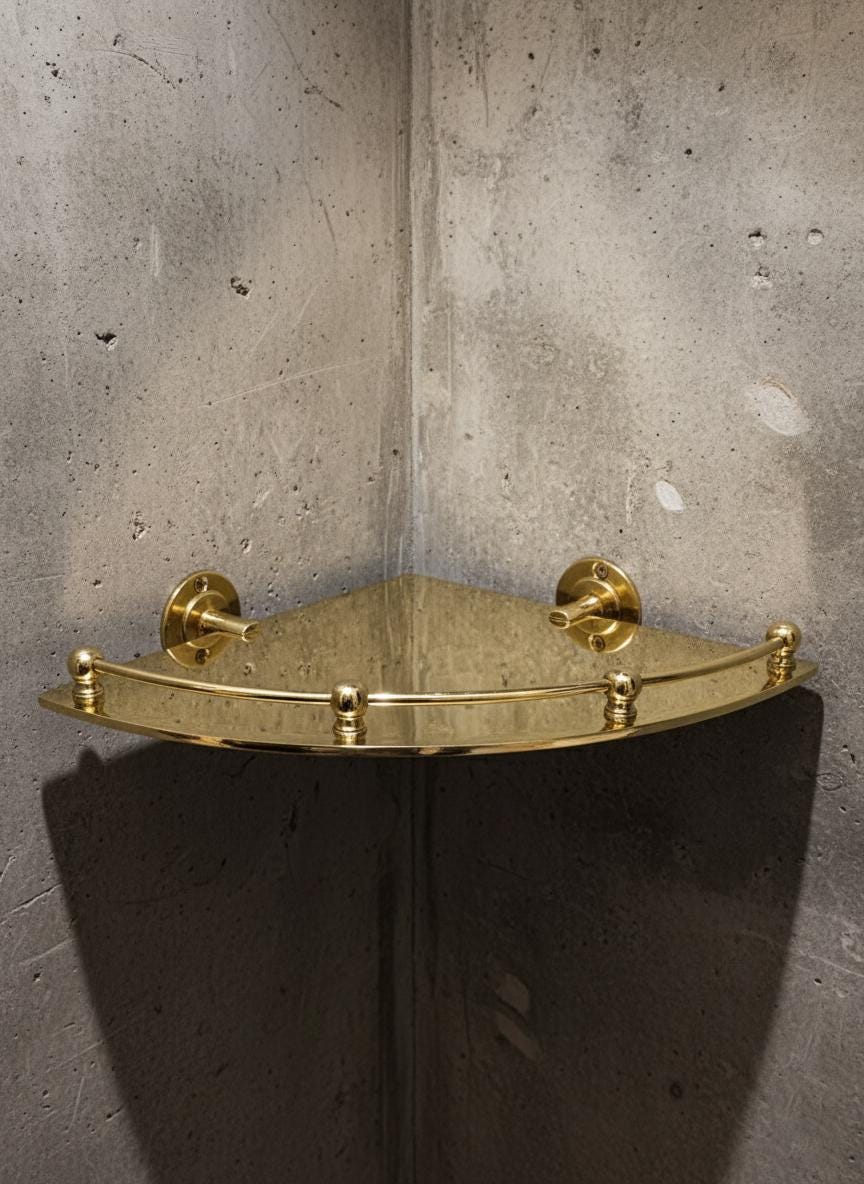 Gold corner shelf against a concrete wall