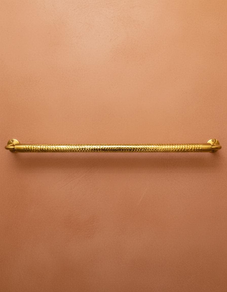 Gold handle on a pinkish-brown wall