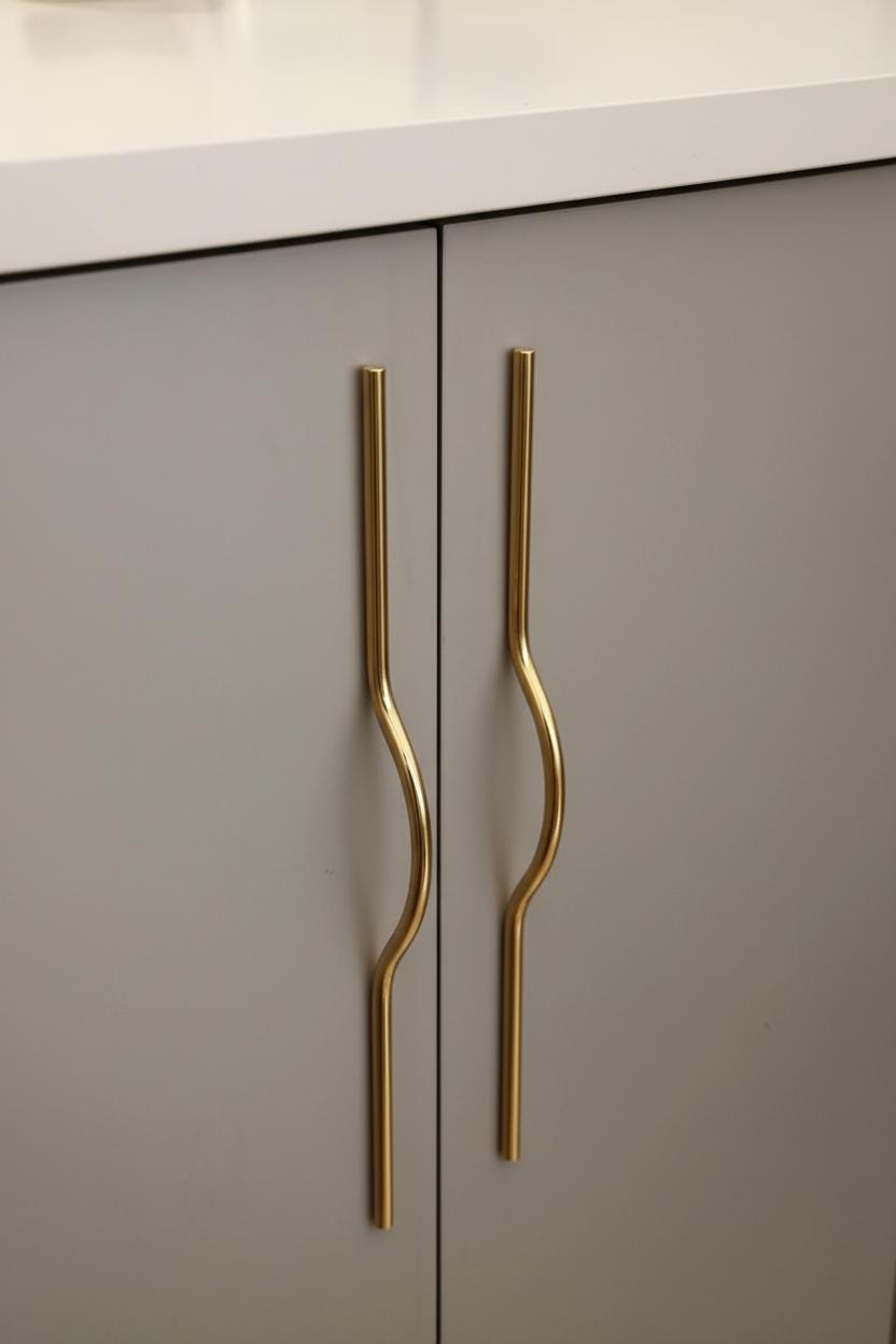 Gray cabinet with gold handles in a kitchen setting