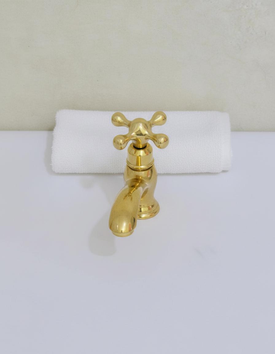 Gold faucet on a white background