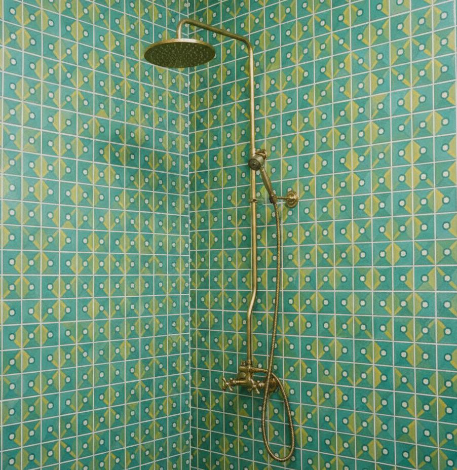 Shower setup against a patterned teal wall