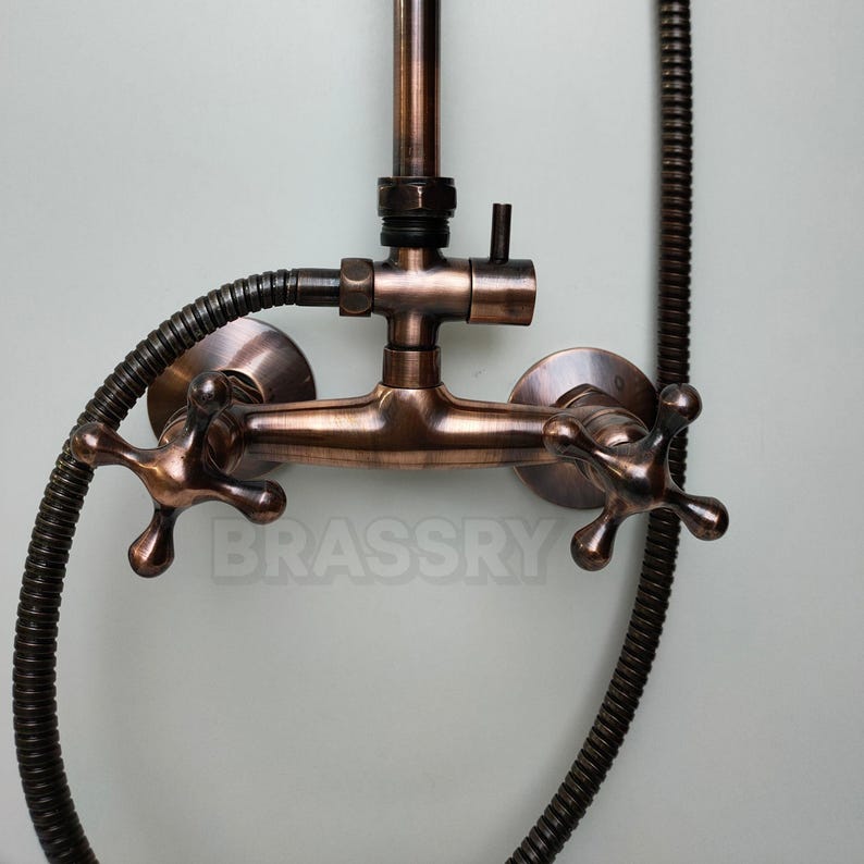 Antique brass and copper shower fixture with exposed piping

