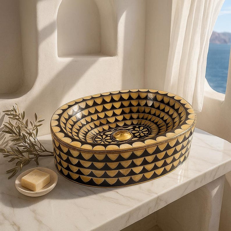 Artisan oval brass vessel sink with black, bone & resin inlay. Handcrafted for luxury bathrooms, spas, and designer vanities. Includes brass drain.

